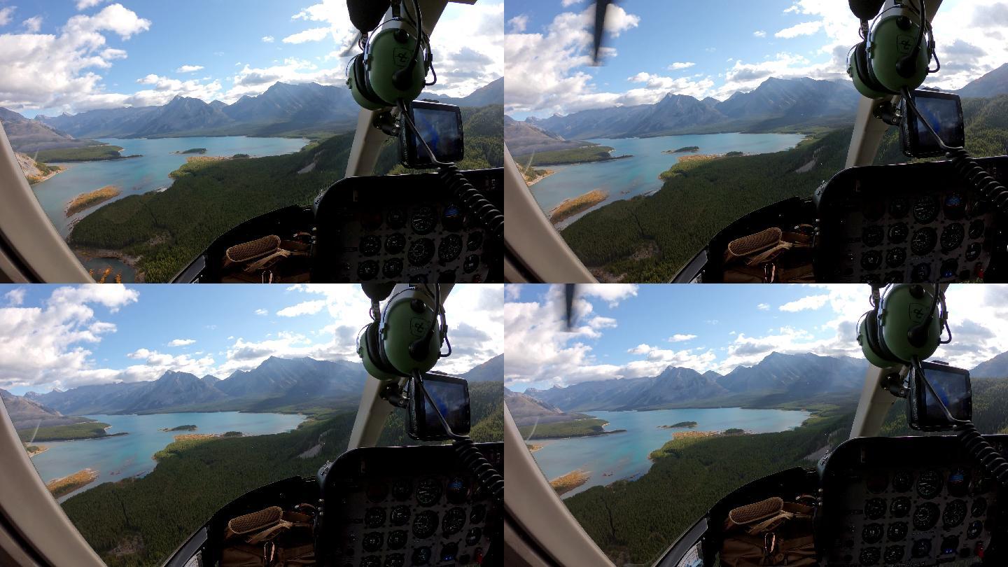 在洛基山脉绿松石湖的秋天森林里，飞行员驾驶直升机