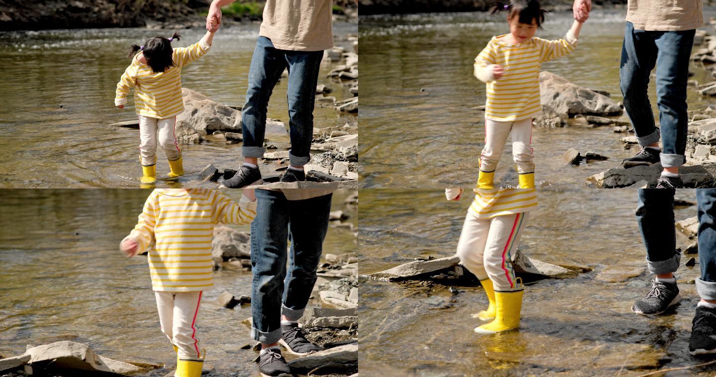 把自己带到水里流淌的小溪黄色雨鞋亲子
