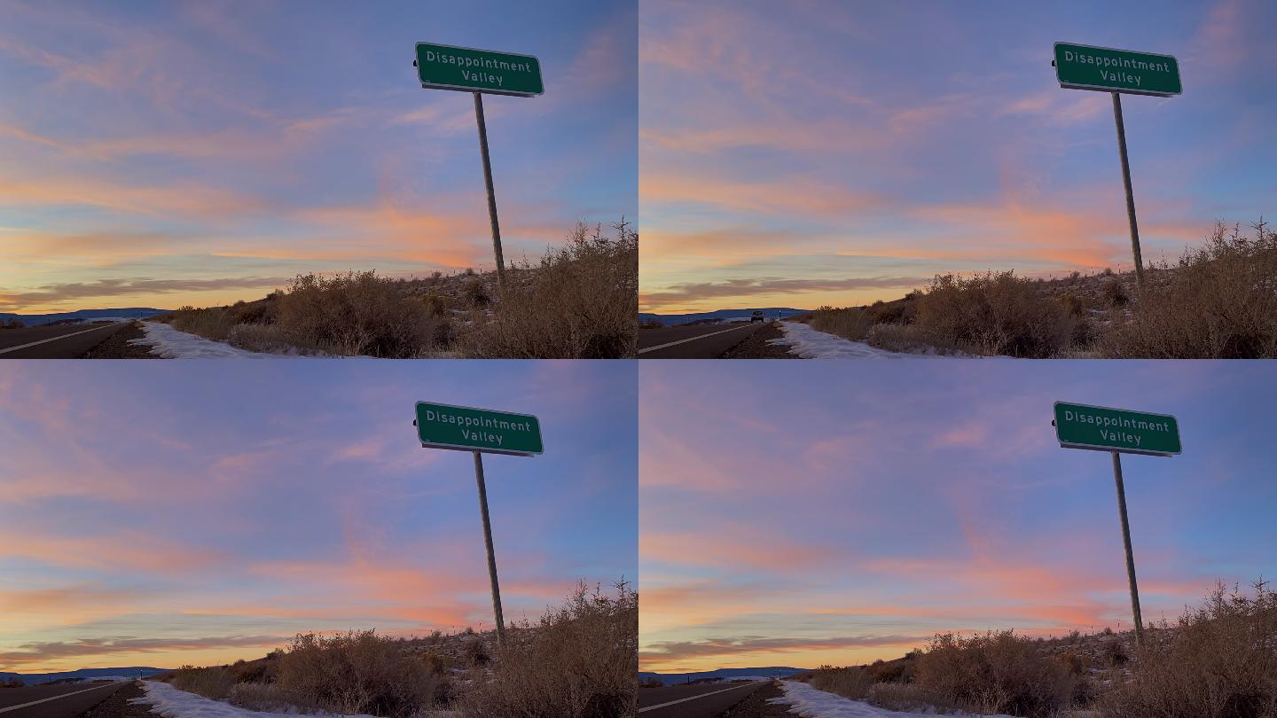 科罗拉多州一个真实路标的黄昏时分，路标上写着失望谷，象征着一个极度绝望和沮丧的地方
