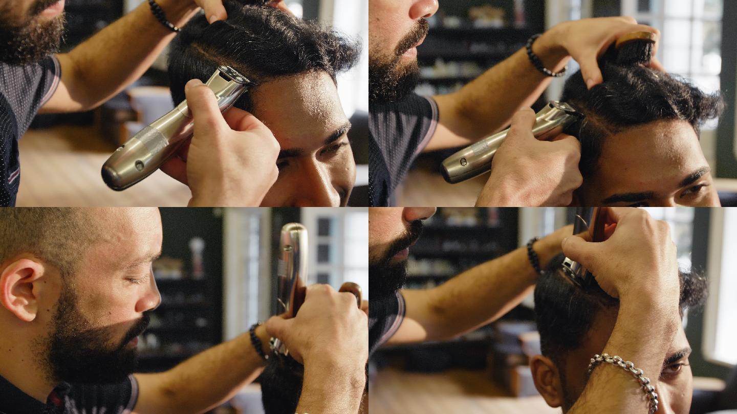 理发师在理发店用电动剃须刀刮男人的头发