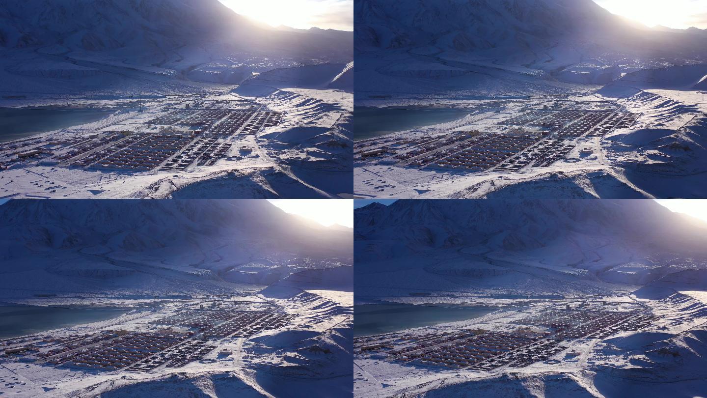 阳光照射雪山下的小镇 新疆 布伦口