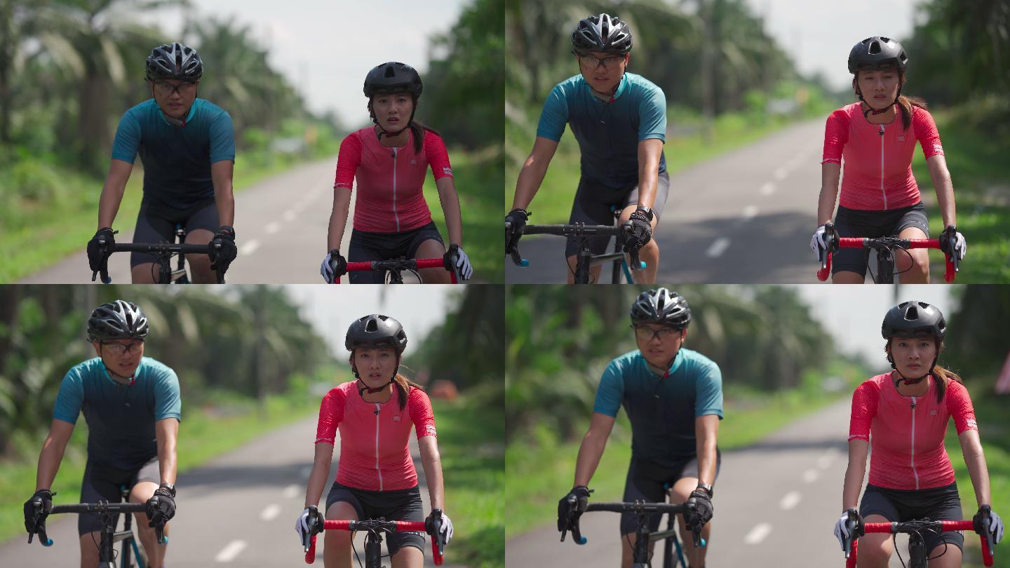 周末，一对精疲力竭的亚裔中国夫妇骑着公路自行车在炎热的阳光下一起在乡村骑行