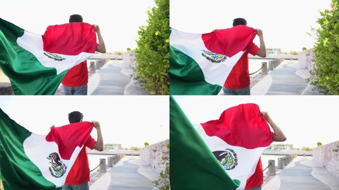 十几岁的拉丁男孩在户外举着墨西哥国旗行走