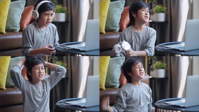 周末假期，亚洲男孩戴着耳机，玩着笔记本电脑在线游戏，坐在家客厅的地板上玩着既兴奋又有趣的游戏，儿子独