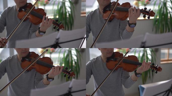 男小提琴家在家排练乐曲