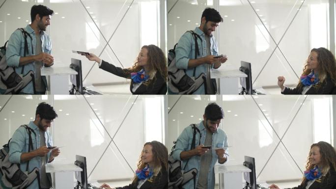 微笑的高加索女性航空公司工作人员在机场值机柜台归还客户护照