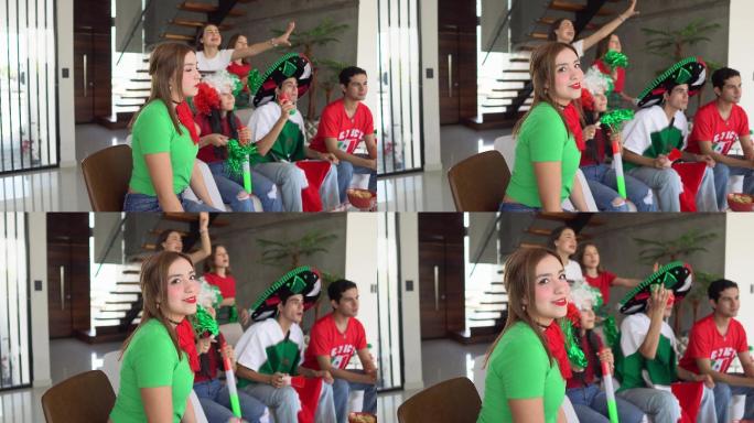 一名少女与朋友在家观看墨西哥足球队比赛的照片