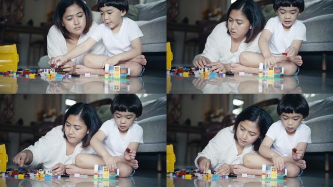 小男孩和妈妈玩塑料积木