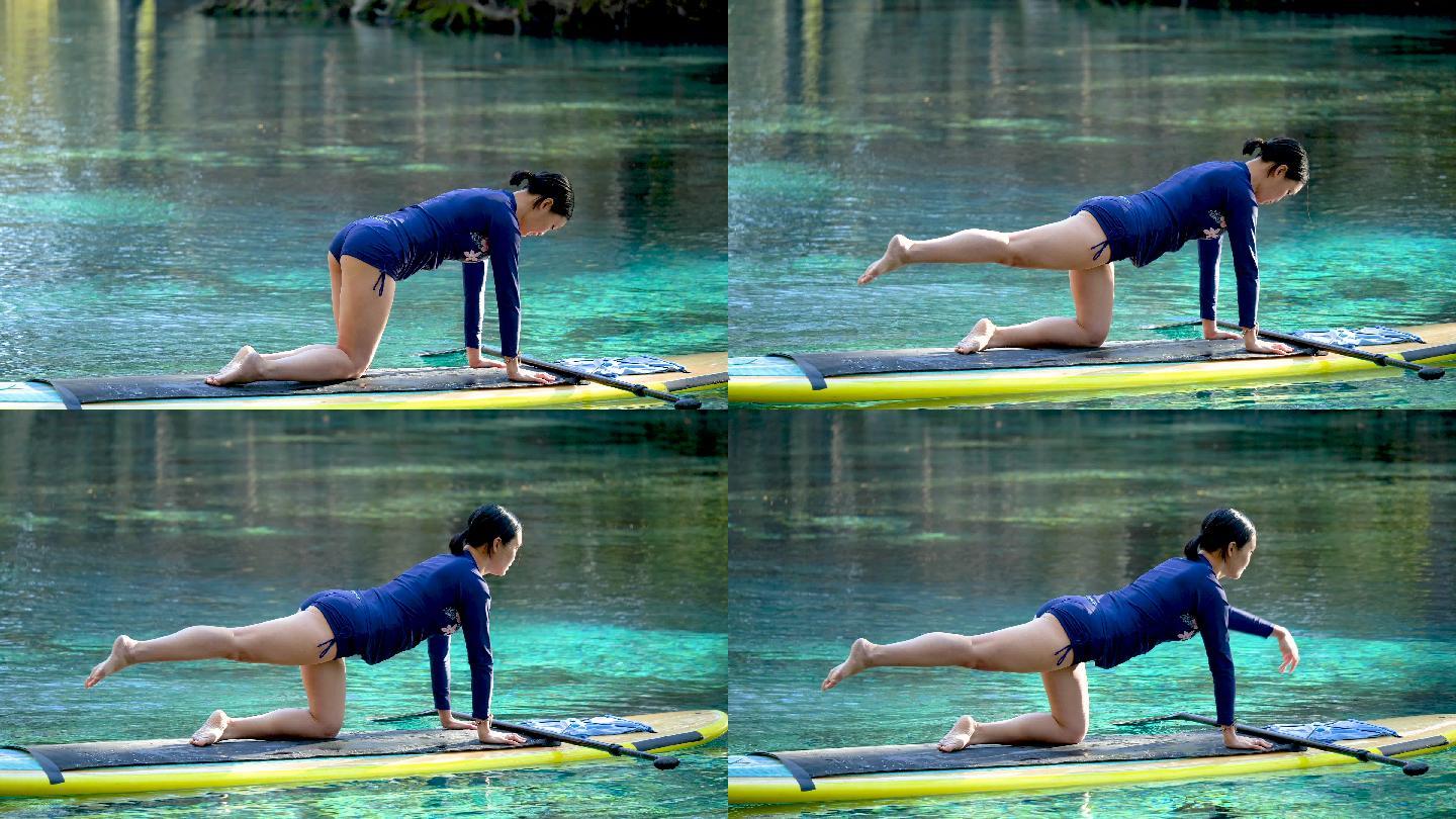 女子在桨板上做瑜伽