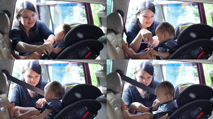 妈妈把男婴放在车里的儿童座椅上