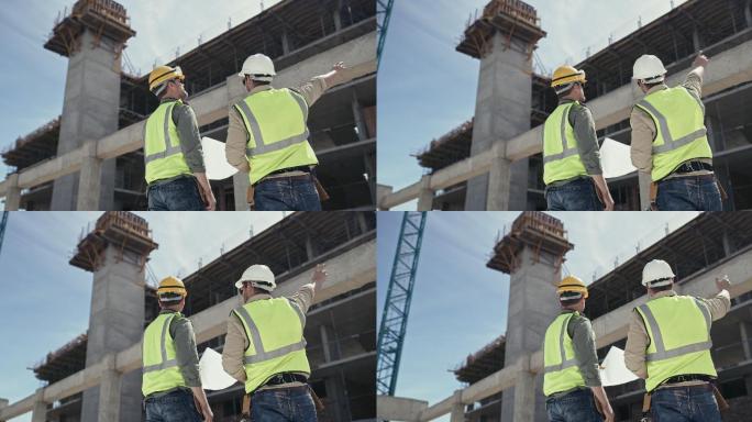 两名男子在施工现场一起工作时看建筑平面图的4k视频片段