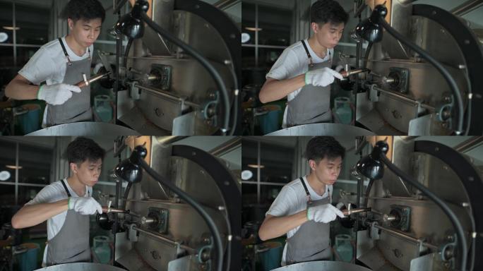 亚裔中国工匠微笑着拿着提尔从咖啡烤箱中提取咖啡豆烘焙生咖啡豆气味检查