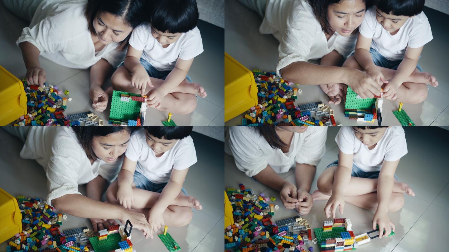 男孩和妈妈玩塑料积木
