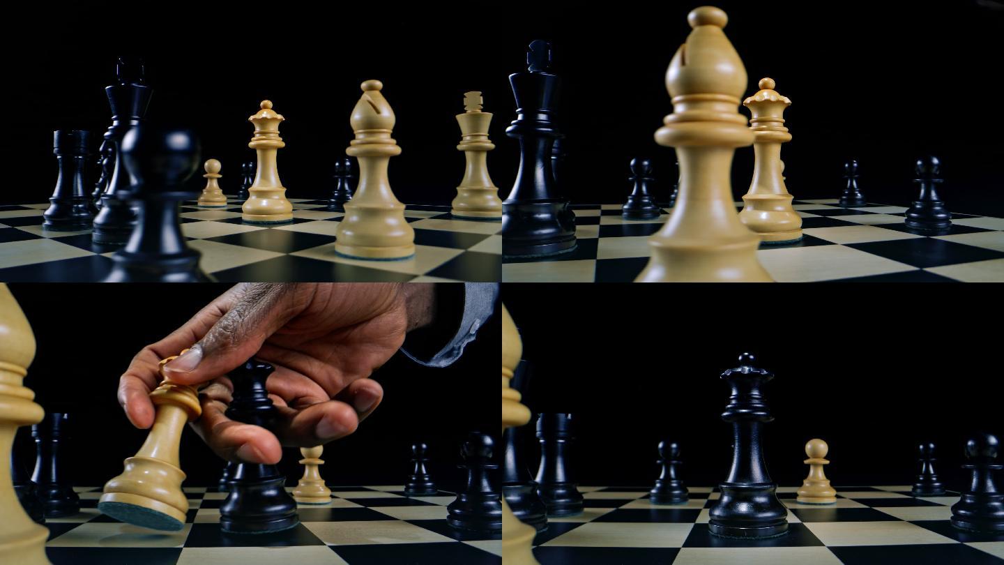 在国际象棋比赛中，DS男子用黑色的手拿着白色的皇后
