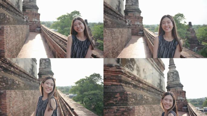 泰国大城府（Ayutthaya）Z代女旅行者，在一座看起来像是探险的寺庙里逗留。