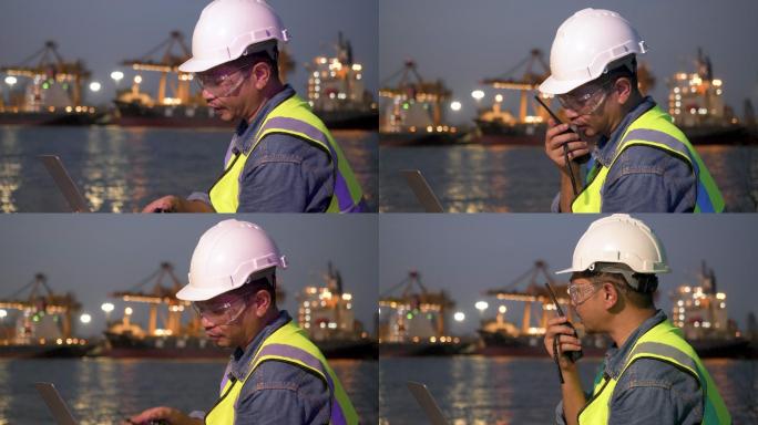 亚洲男性专业工程师集装箱领班在头盔架上工作，并使用对讲机进行指挥。