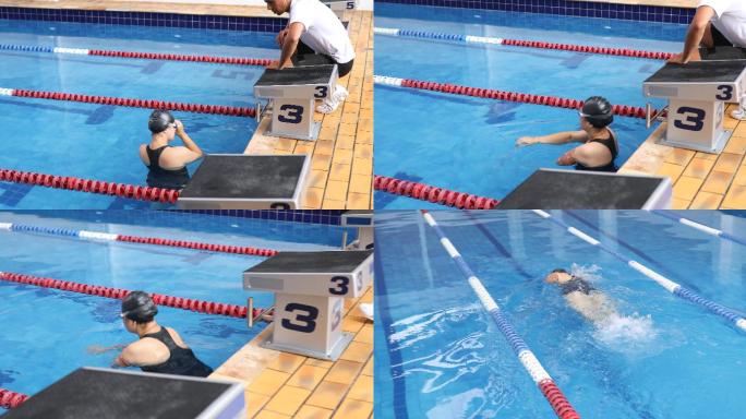 教练在泳池内指导一名持枪女游泳运动员