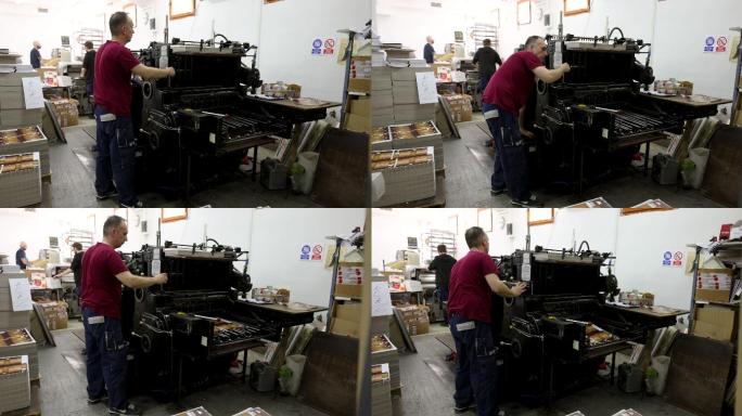 印刷厂工人，启动自动印刷机