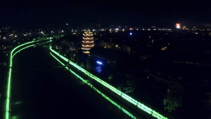 彝人古镇河边古塔夜景航拍环绕4k视频