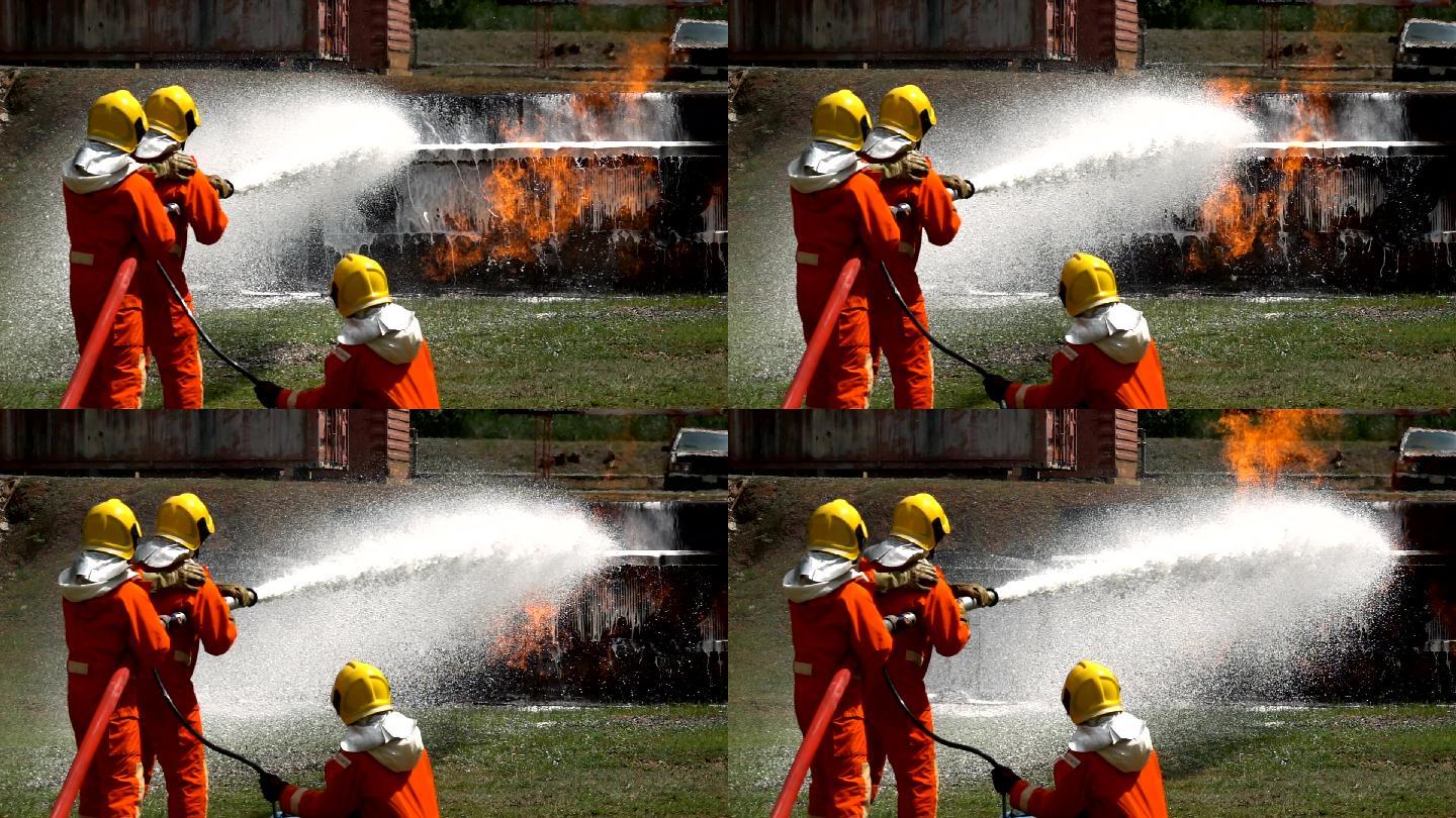 消防队员用消防水带和泡沫灭火剂扑灭卡车事故火灾的特写镜头
