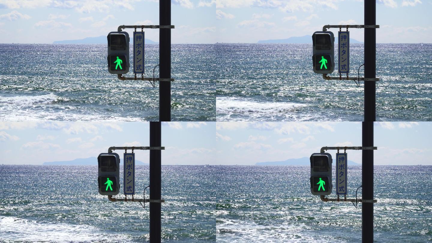背景为大海的红绿灯。灯变绿了。