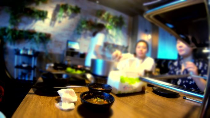 一群十几岁的亚洲人在台湾的购物中心吃着涮涮涮锅，这是都市人的生活方式