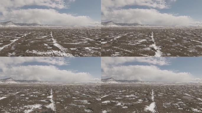 慢动作无人机拍摄美丽的科罗拉多沙漠冬季丘陵和山脉上的假山降雪极端天气视频系列