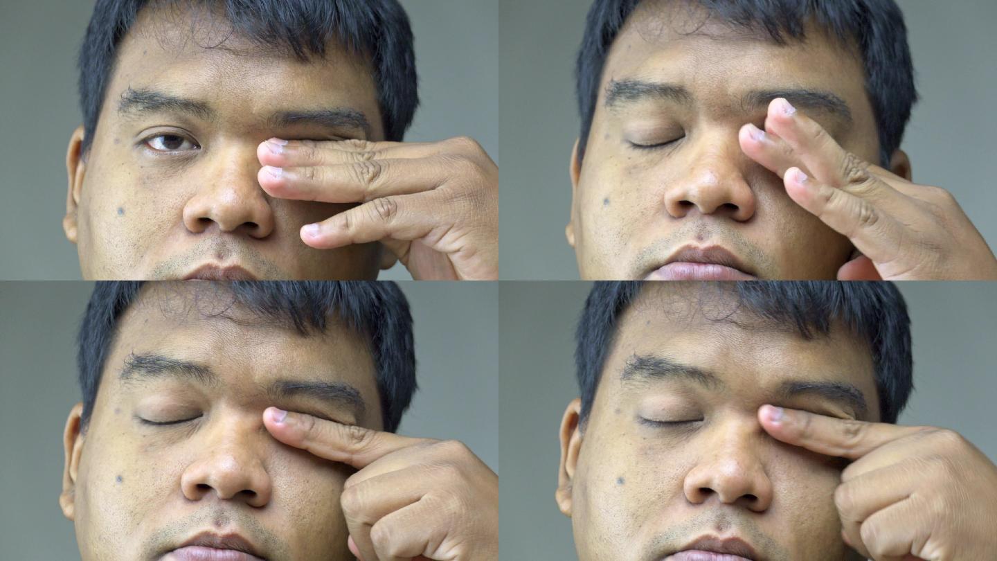 那个人用手指蹭眼睛。缓解长期使用眼睛后的眼睛疲劳。
