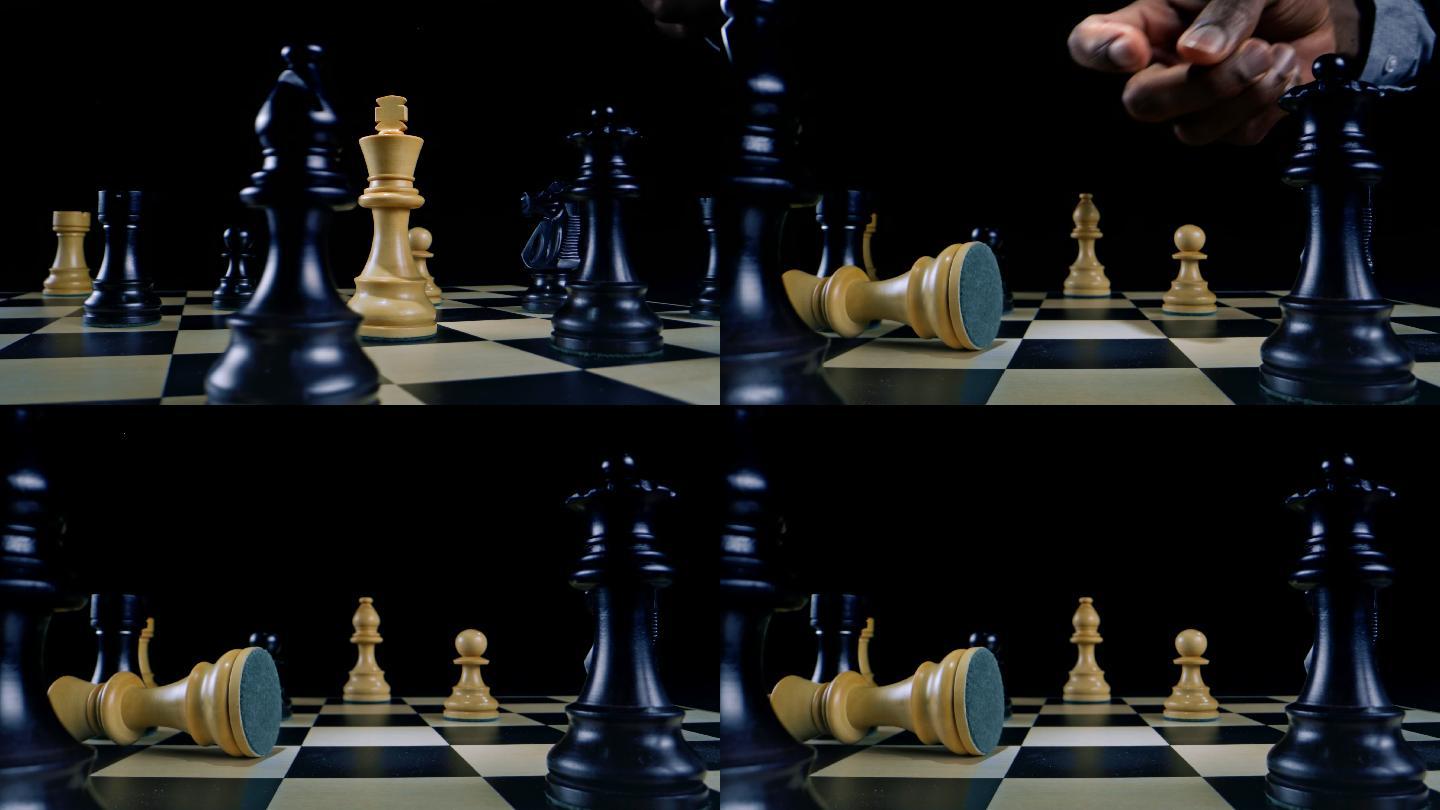 象棋比赛中，一只棕色的雄性手翻倒了白王