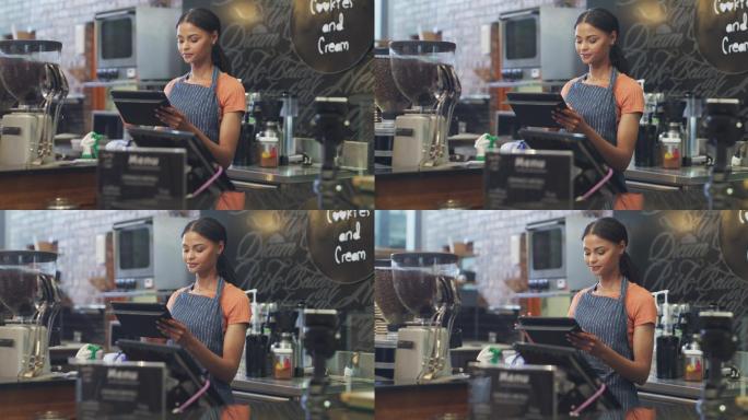 一名年轻女子在咖啡馆工作时使用数字平板电脑的4k视频片段