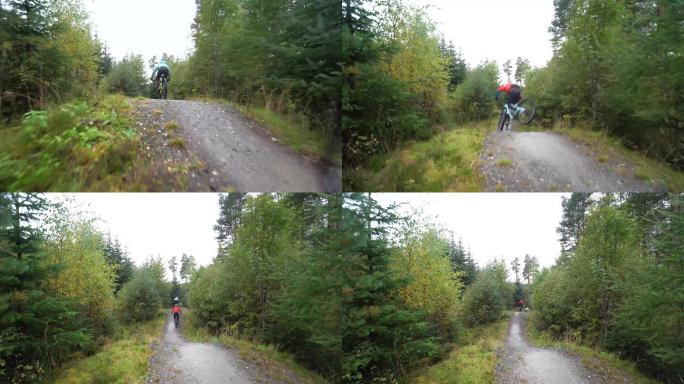 两名山地自行车骑手沿着森林自行车道快速骑行