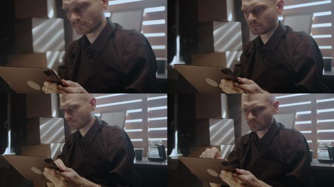 一位严肃的中年男子在数字平板电脑的屏幕上阅读文本