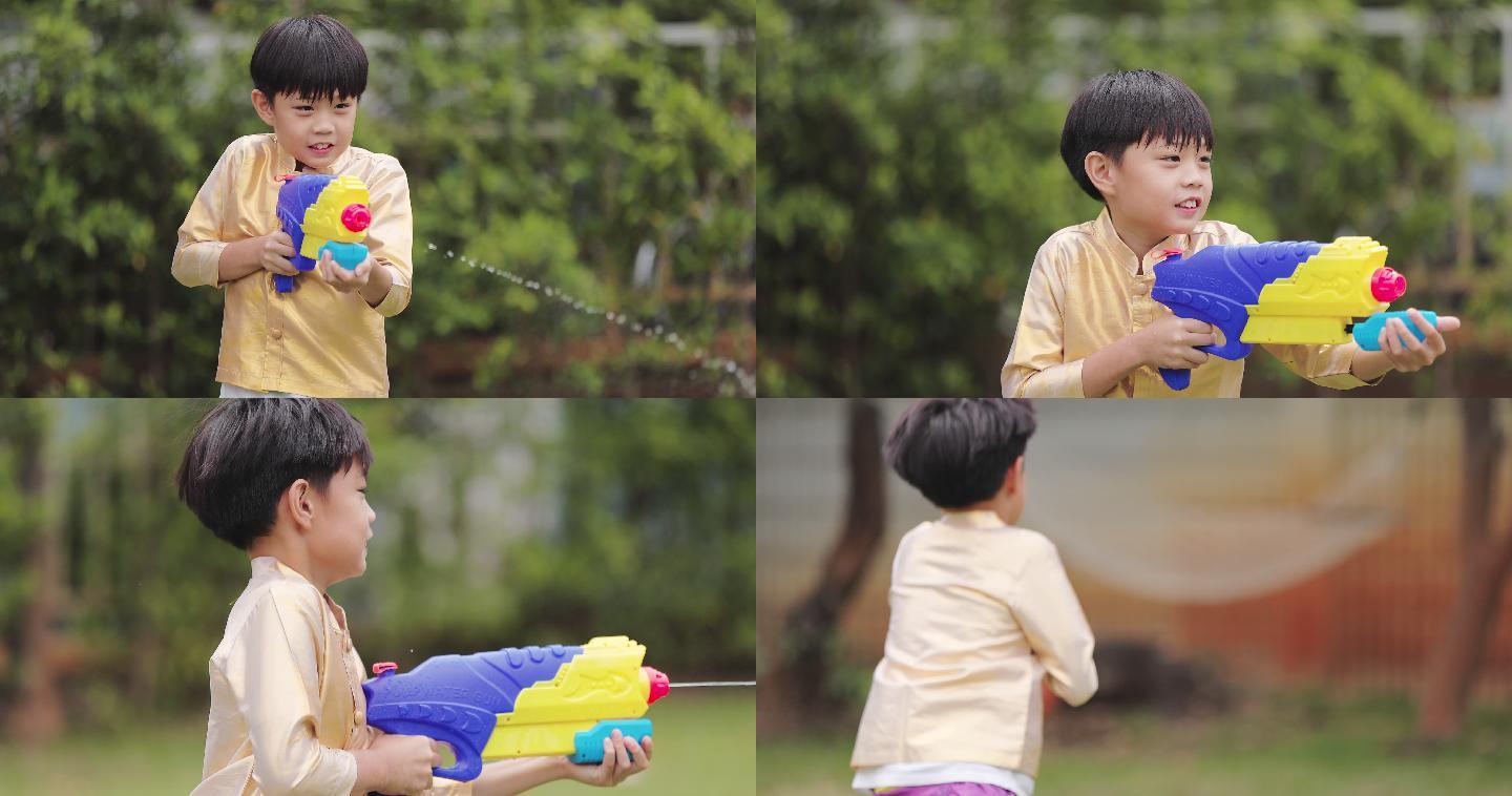泼水节穿泰国传统服装的孩子们玩水枪