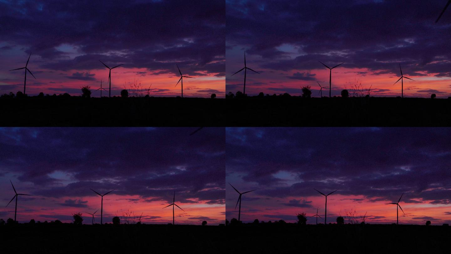 日落时的4K剪影风电场。