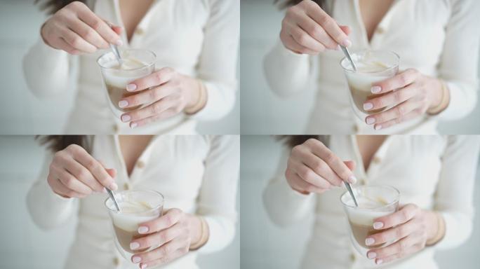 一个穿着白色搅拌咖啡的女人的详细照片