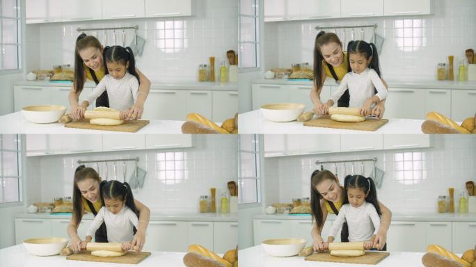 母亲和女儿在厨房一起烤面包