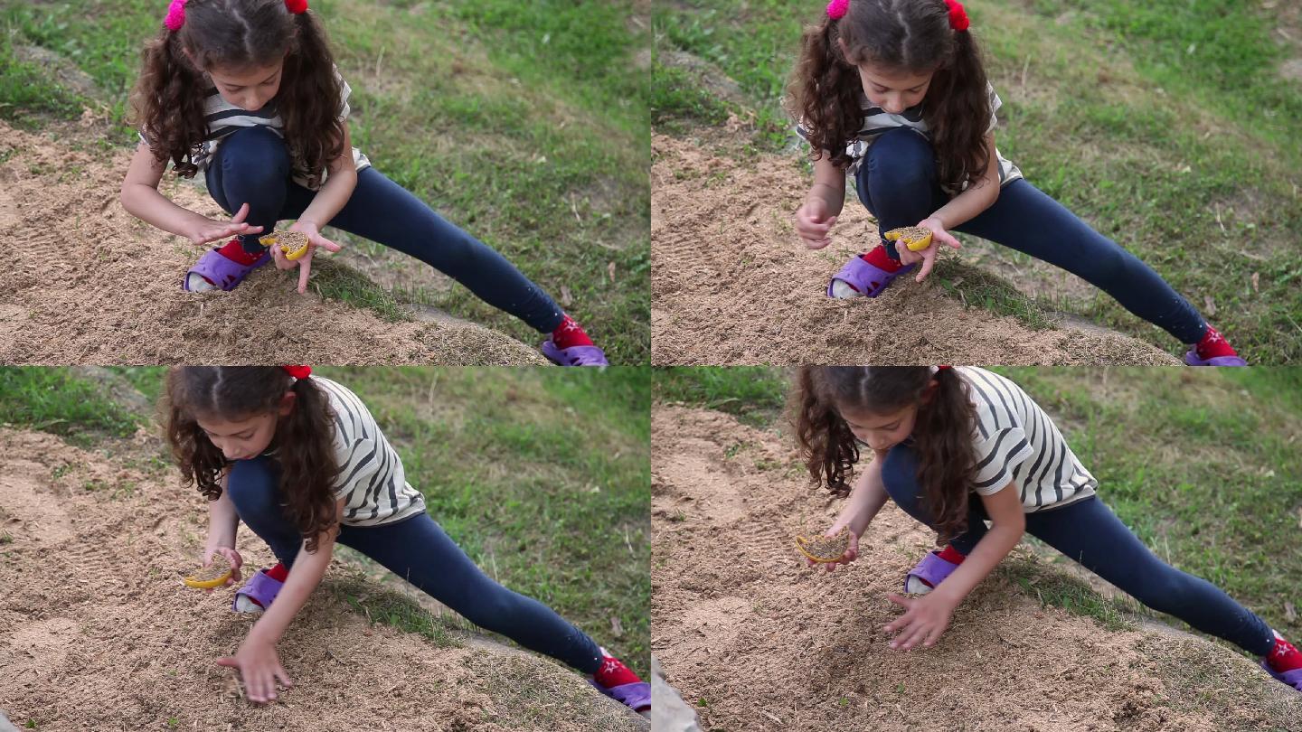 小女孩在院子里玩沙子