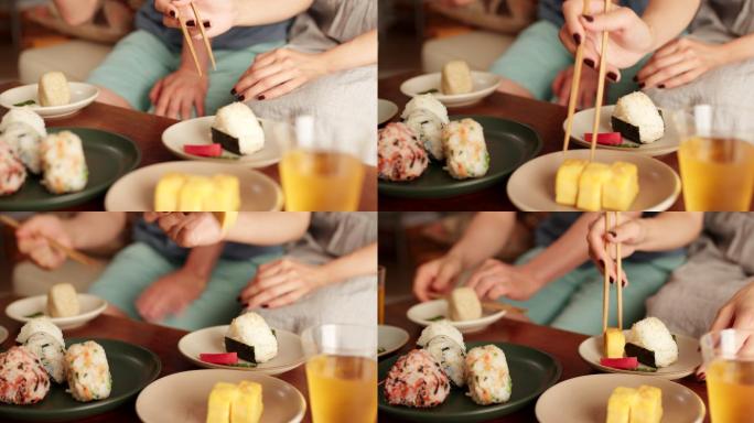 一对年轻夫妇在家吃日本饭团的特写镜头