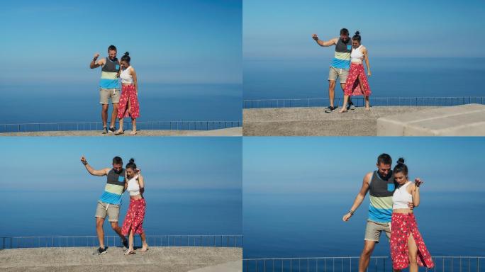 海景观上的幸福夫妻。在阳光下跳舞