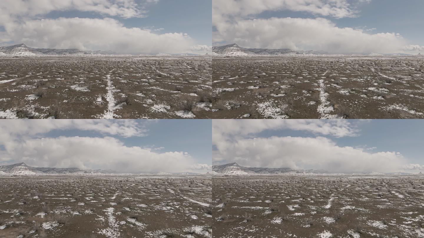 慢动作无人机拍摄美丽的科罗拉多沙漠冬季丘陵和山脉上的假山降雪极端天气视频系列