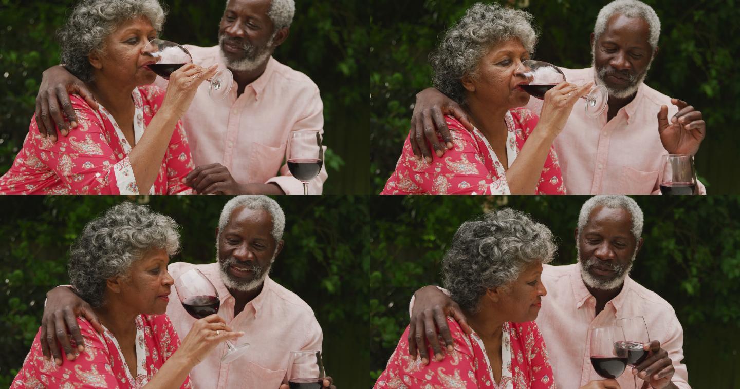 一对年长的非裔美国夫妇在社交距离中享用一杯葡萄酒