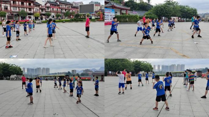 古城广场学武术的少儿学基本功师傅带徒弟