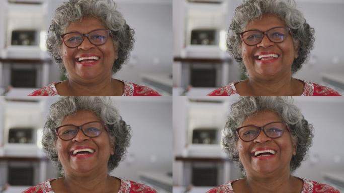 一位年长的非裔美国女性在社交距离中对着镜头微笑