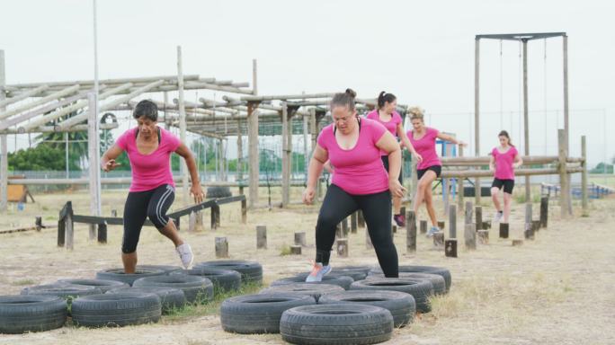 Female friends enjoying exercising at boot camp to