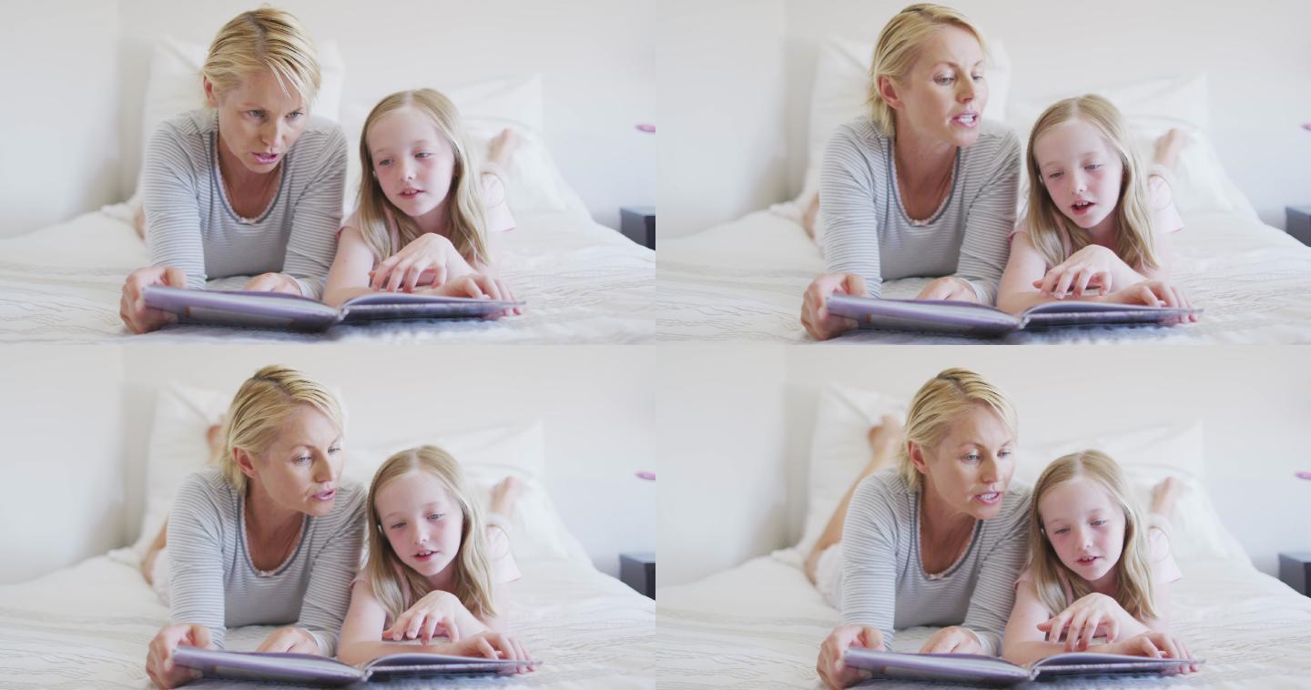 正面的白人妇女读故事给她的女儿在床上