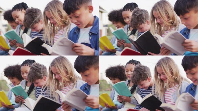 一群孩子在读书儿童快乐阅读草坪上阅读的孩