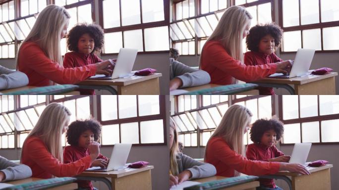 女老师和男孩在课堂上使用笔记本电脑
