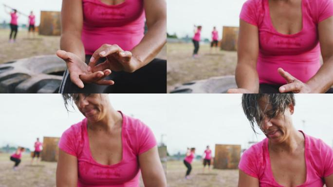混合种族妇女在训练营锻炼后休息