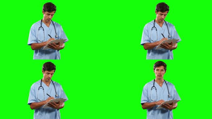 前视图的医生书写与绿色屏幕
