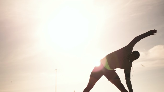 Man performing stretching exercising on the beach